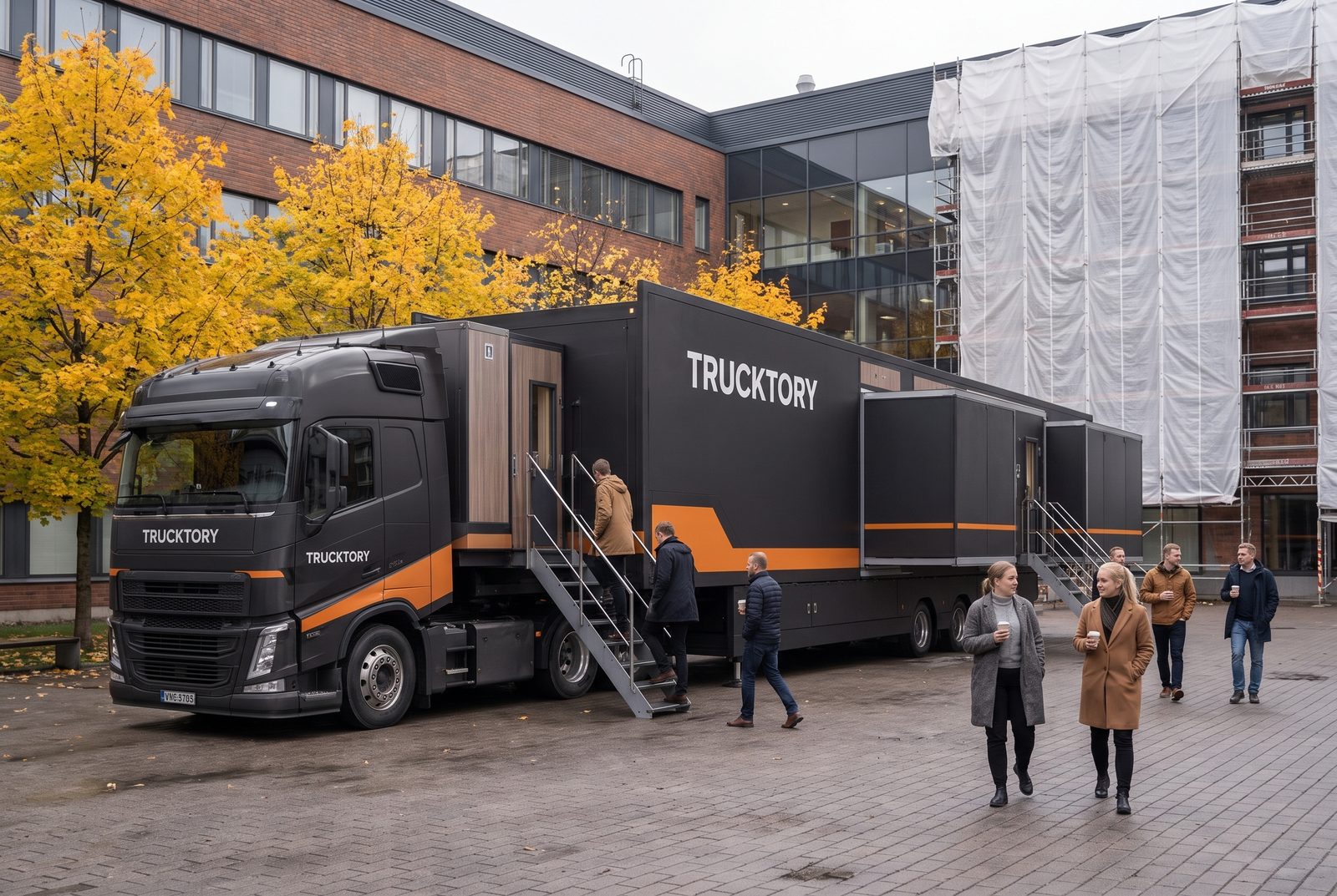 Trucktory-rekka toimistorakennuksen pihalla remontin aikana, toimistotyöntekijät nousevat portaita